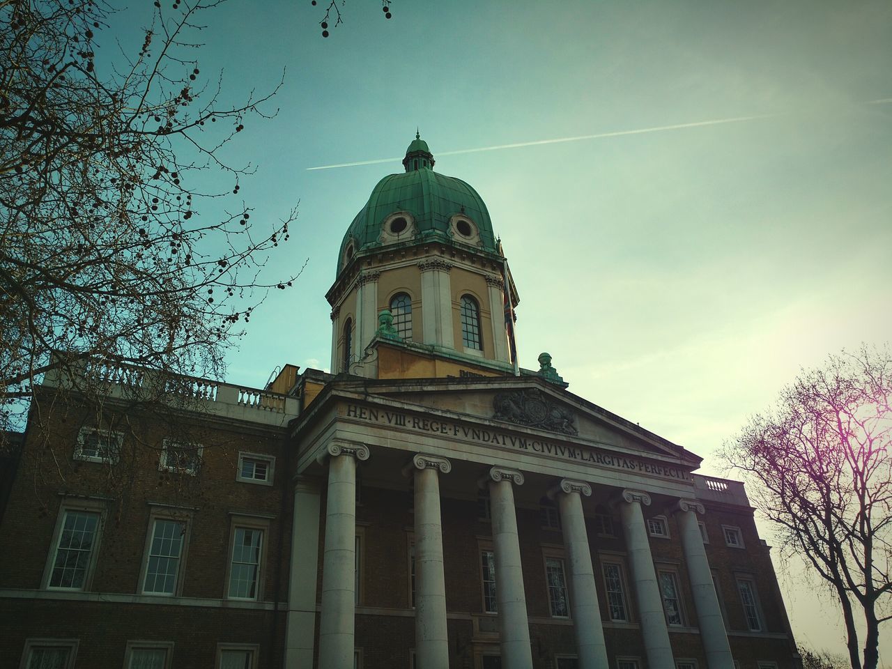 architecture, building exterior, built structure, low angle view, sky, place of worship, religion, church, spirituality, famous place, cathedral, travel destinations, tree, history, dome, tower, city, outdoors