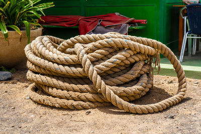Close-up of ropes tied on wooden post