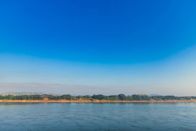 Scenic view of lake against blue sky