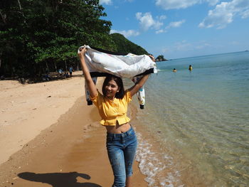 Portrait of woman standing on beach