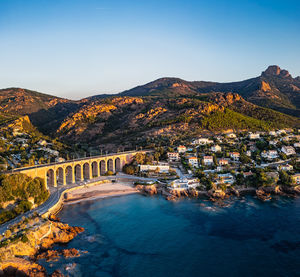 High angle view of townscape by sea against sky