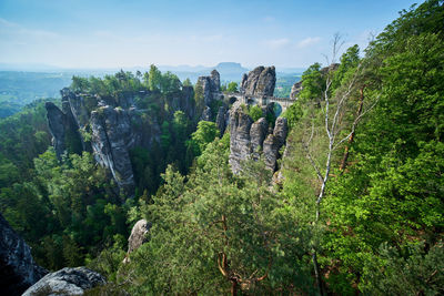 Panoramic view of trees and mountains against sky