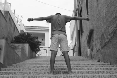 Rear view of man walking on road