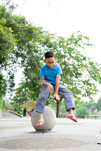 Full length boy jumping at park