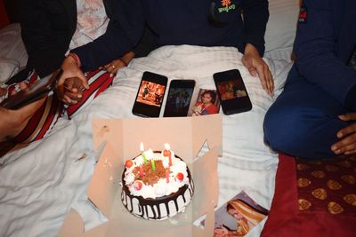 High angle view of people on cake