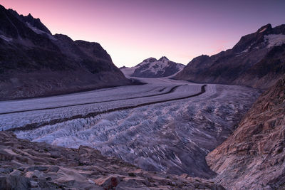 Scenic view of mountains and glaciers against sky during sunset