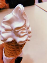 Close-up of hand holding ice cream cone