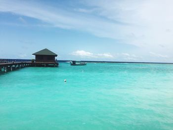 Scenic view of swimming pool by sea against sky