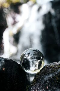Close-up of crystal ball on rock