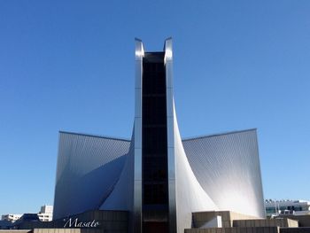 Low angle view of building against clear blue sky