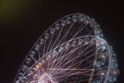 Low angle view of ferris wheel against sky at night