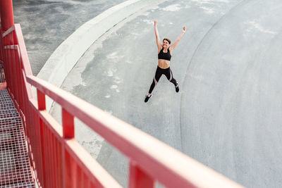 High angle view of woman jumping outdoors