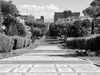 Footpath amidst buildings in city