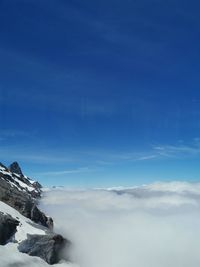 Scenic view of snowcapped mountains against blue sky