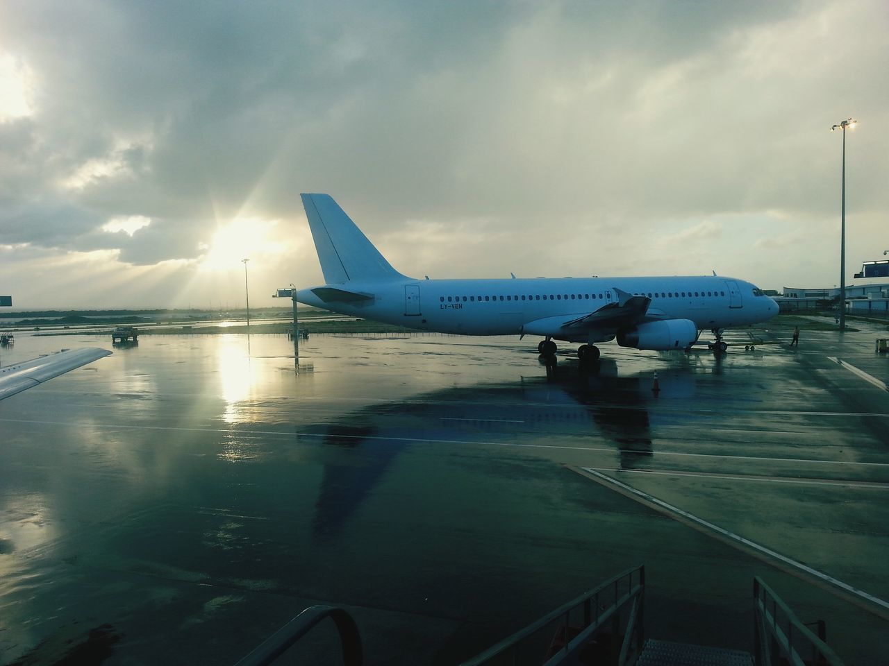 transportation, mode of transport, sky, cloud - sky, cloudy, car, land vehicle, sun, airplane, sunlight, cloud, sunbeam, nautical vessel, road, travel, water, sea, weather, air vehicle, nature