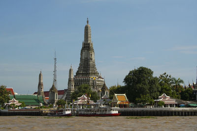 View of temple by building against sky