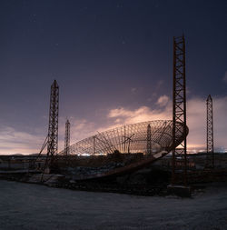 Low angle view of crane against sky at night