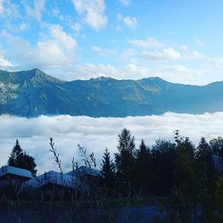 Scenic view of mountains against cloudy sky