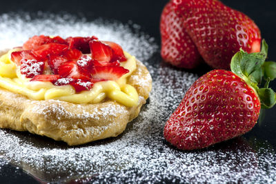 Close-up of cake with strawberries and vanilla