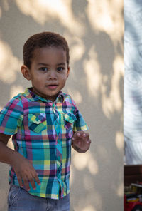 Portrait of cute boy standing outdoors