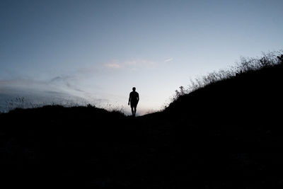 Rear view of man walking on mountain