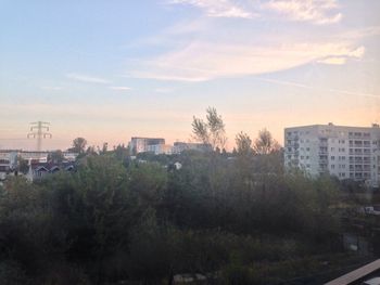 Buildings against sky at sunset