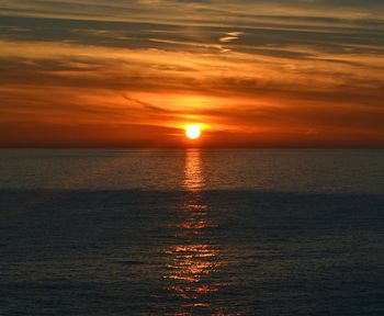 Scenic view of sea against orange sky