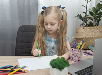 Girl sitting on table