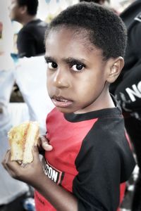 Close-up portrait of boy having food