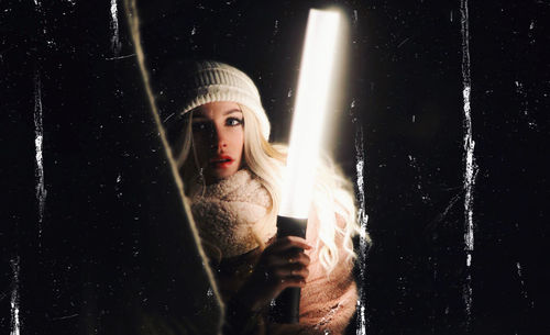 Portrait of young woman using smart phone in winter