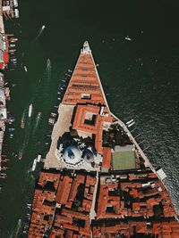 High angle view of buildings by lake in city