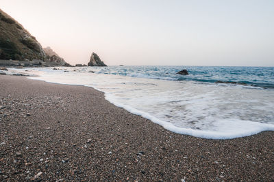 Scenic view of beach against clear sky