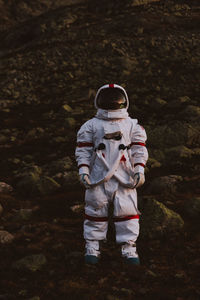 Full length of astronaut standing against sky