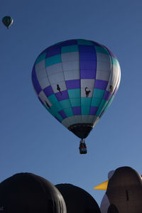 Low angle view of hot air balloon against clear blue sky