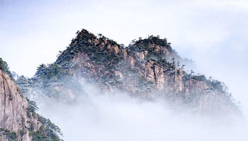 Low angle view of rocks against sky