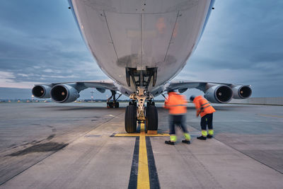 Low angle view of freight airplane. ground staff at airport. preparation cargo plane before flight.