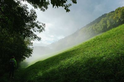 Scenic view of mountains against cloudy sky