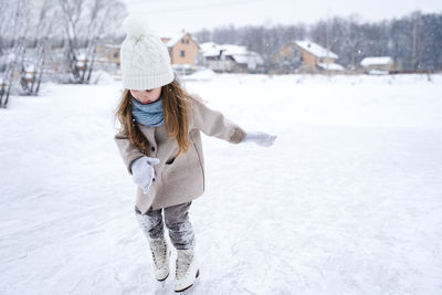 Full length of woman standing in snow