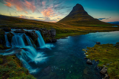 Idyllic view of mountain and waterfalls during sunset