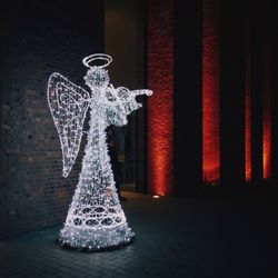 Illuminated fairy outside building