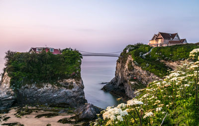 View of buildings by sea against sky