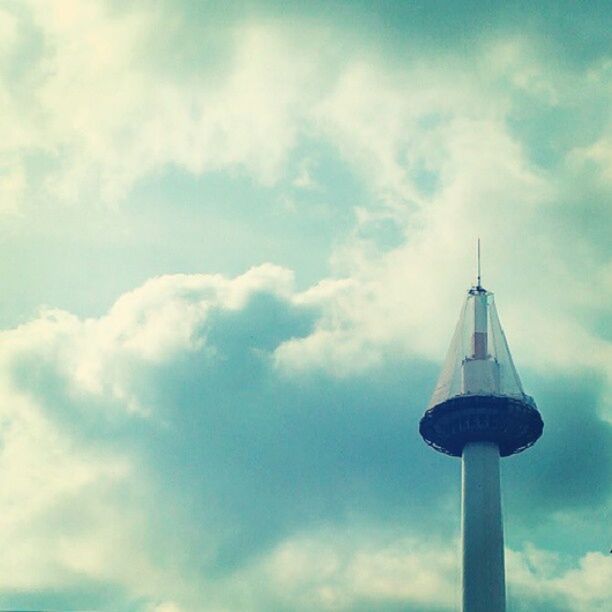 low angle view, sky, cloud - sky, architecture, built structure, tower, building exterior, cloudy, cloud, tall - high, blue, high section, day, no people, outdoors, communication, guidance, communications tower, spire, tall