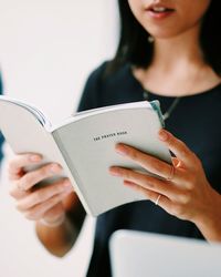 Midsection of woman holding text