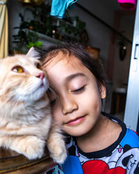 The portrait of a small cute child who embraces the cat tenderly and loves it with happiness.