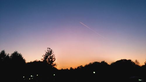 Low angle view of silhouette trees against sky during sunset