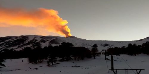 Scenic view of snowcapped mountains against sky during sunset