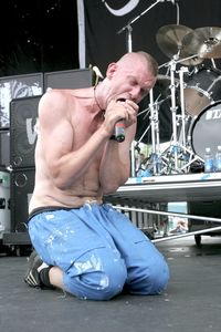 Midsection of shirtless man sitting on metal