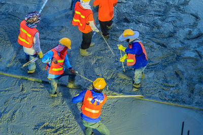 High angle view of people standing in water