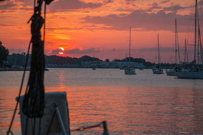 Sailboats in marina at sunset