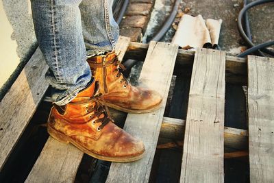 Low section of woman standing on wood